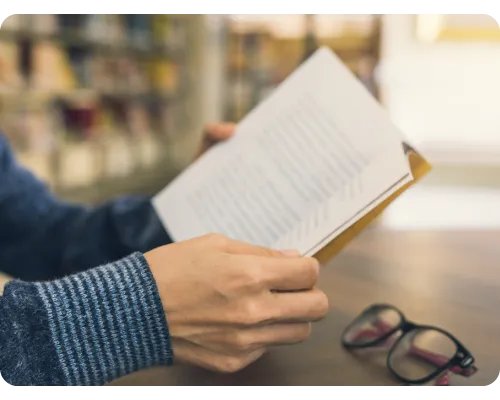 Glossary image man holding a dictionary