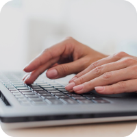 Hands working on a computer