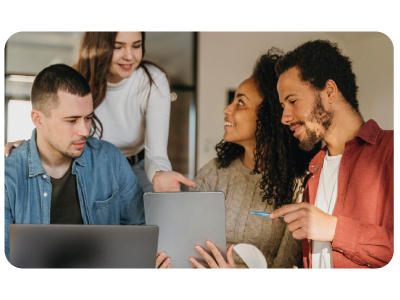 Many people looking at a computer, discussing how fascinating it is.